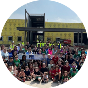  large group of elementary student in front of school that is under construction